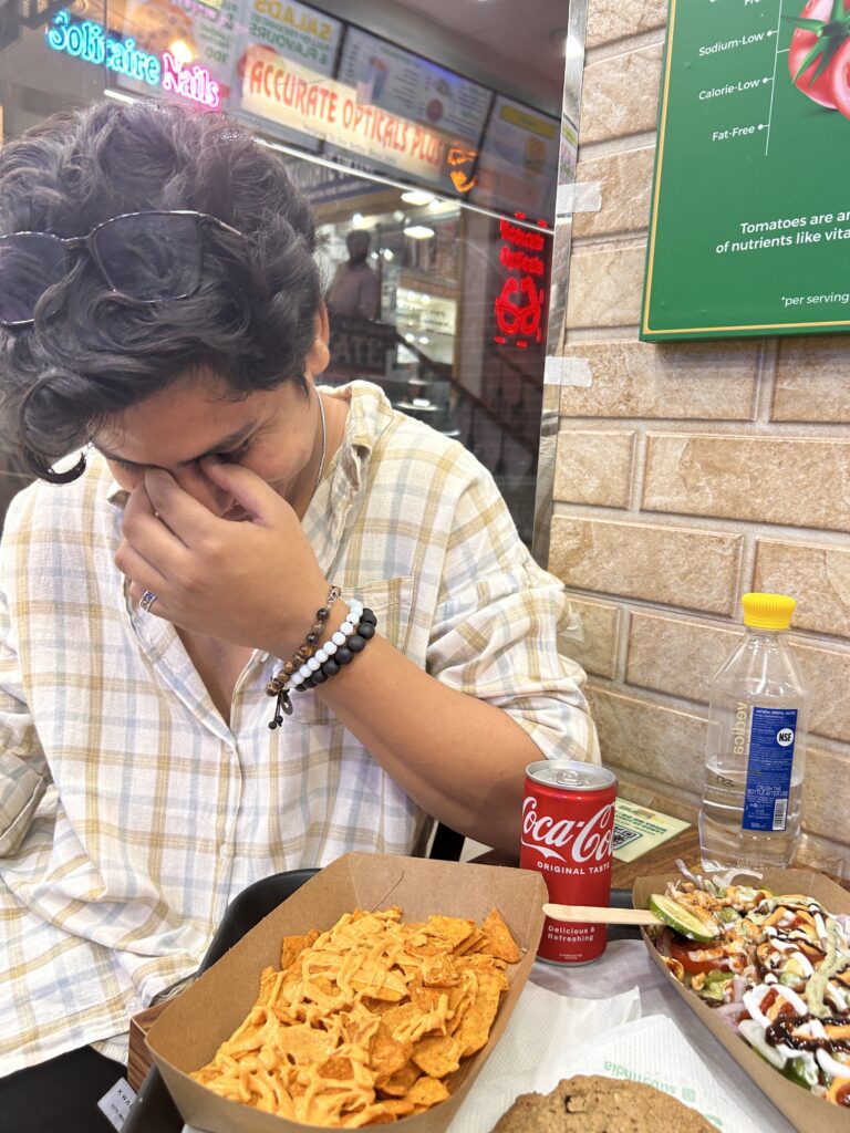 Candid lifestyle food photography of a young man laughing over nachos and Coke – Kapilverse Blog
