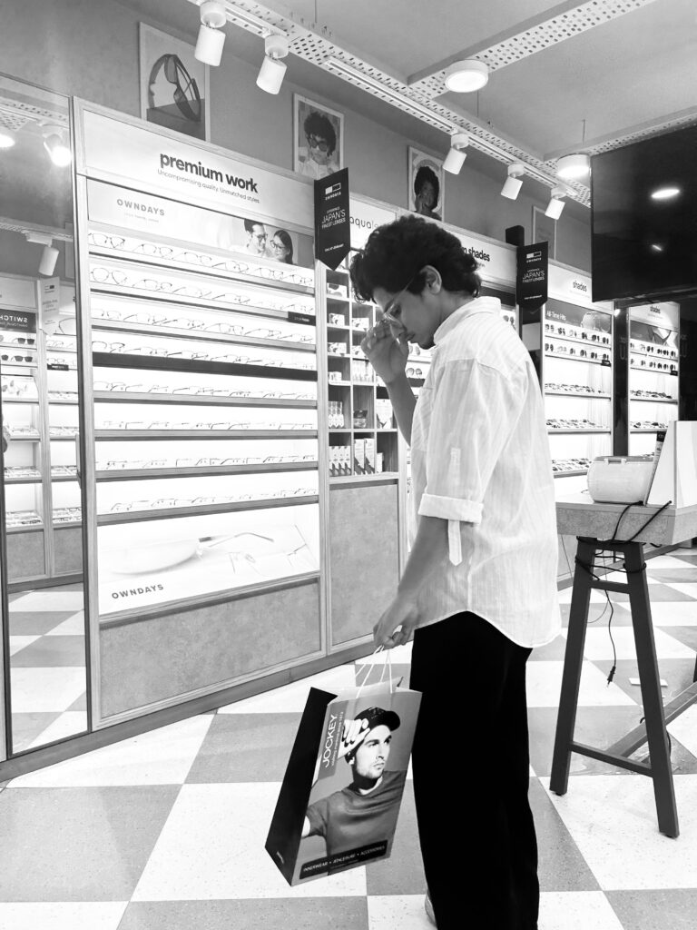Black and white aesthetic lifestyle photography in eyewear store with shopping bag